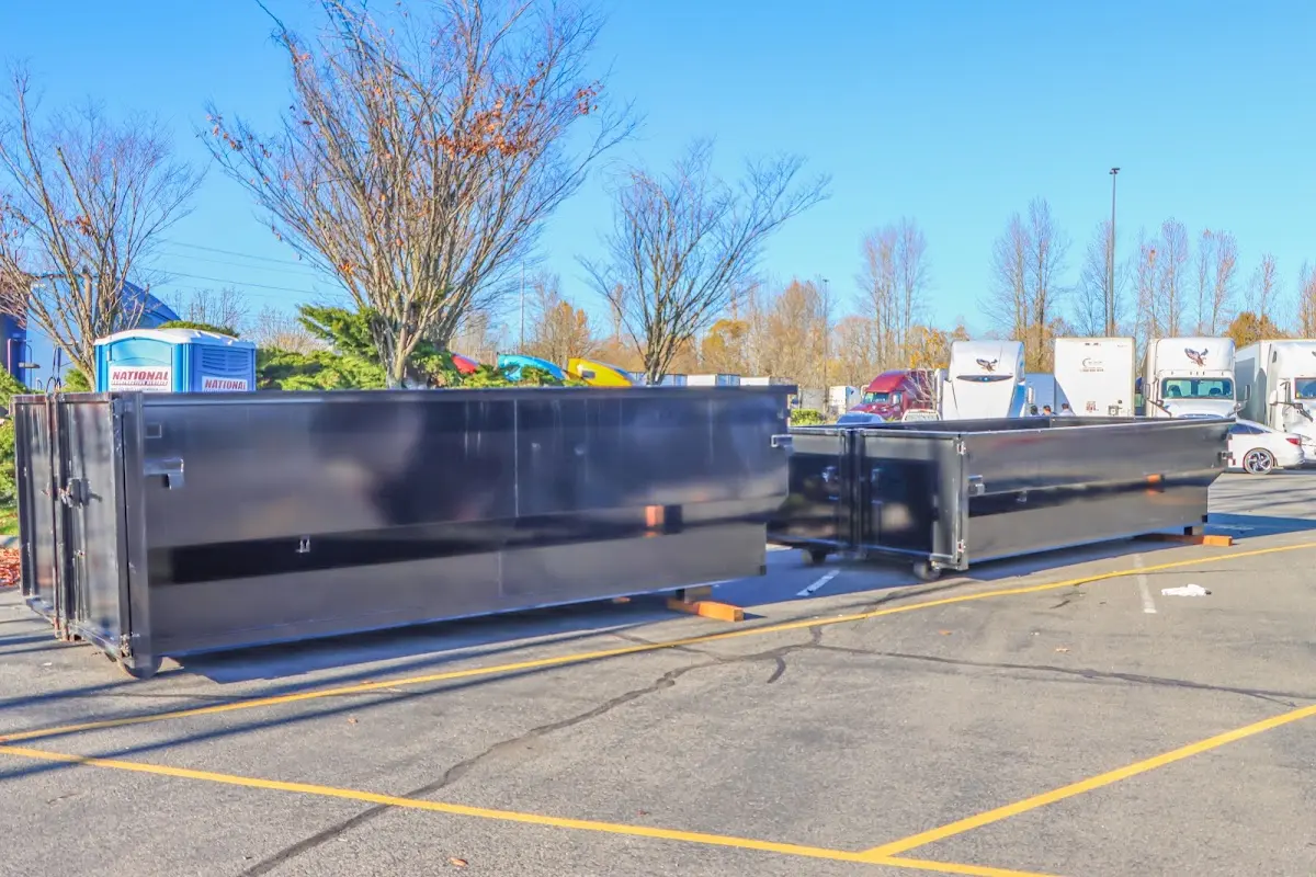 Professional dumpster rental service with roll-off container on residential driveway in Warminster